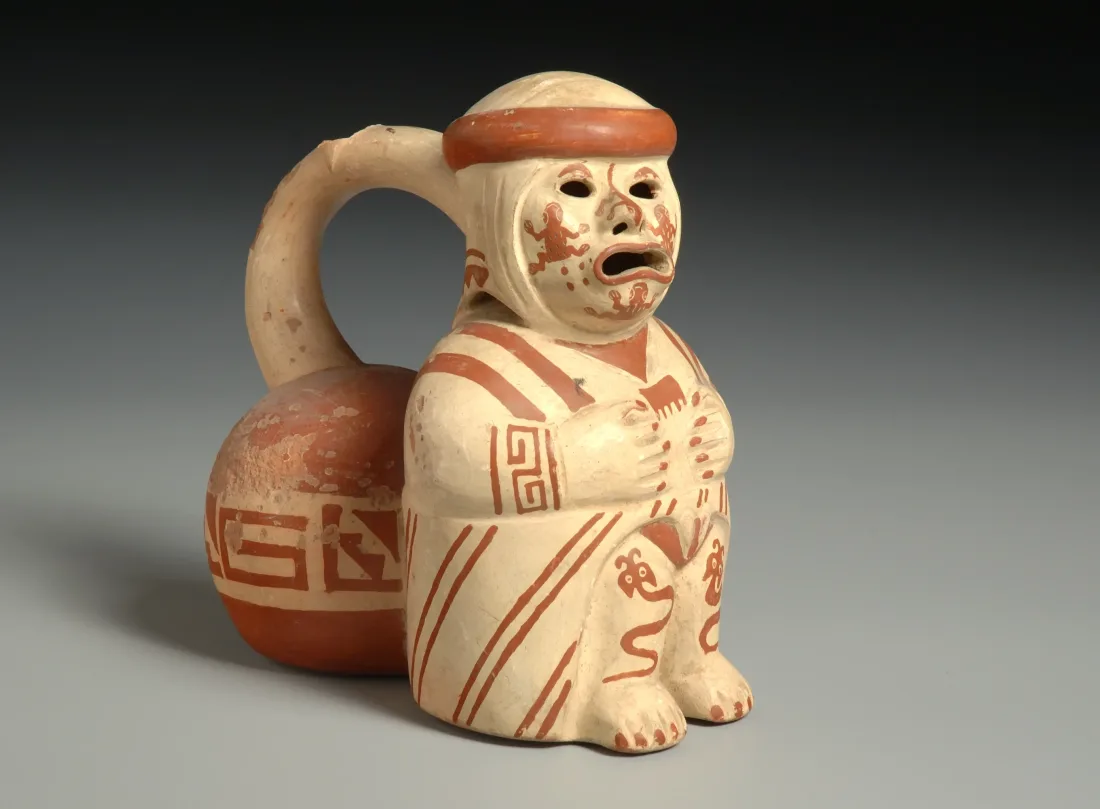 Whistling vessel, sitting human figure, made of fired and painted clay