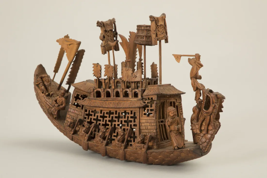 Model of a boat with honorary flags, rowers
